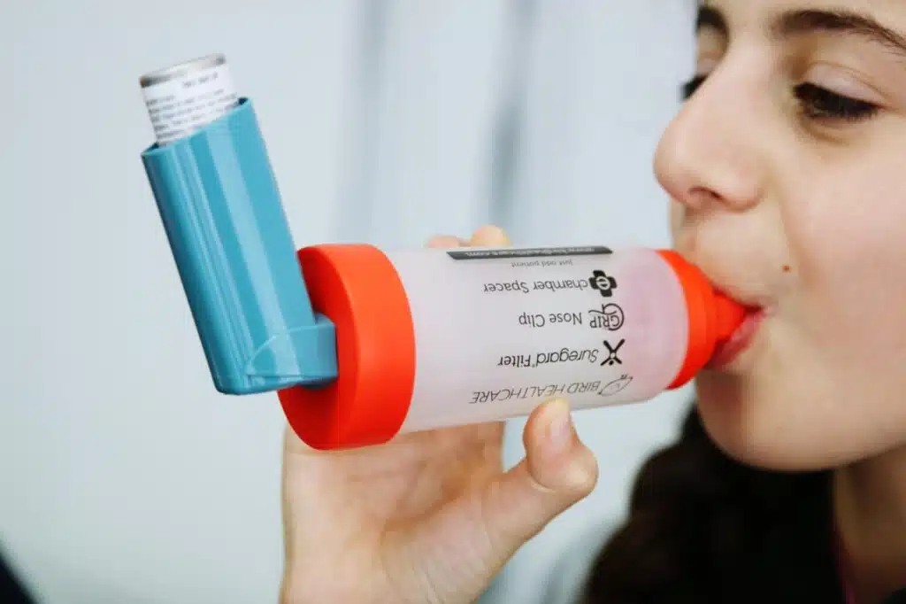 Teen girl using an asthma inhaler device 2026 03 09 22 10 02 utc Large